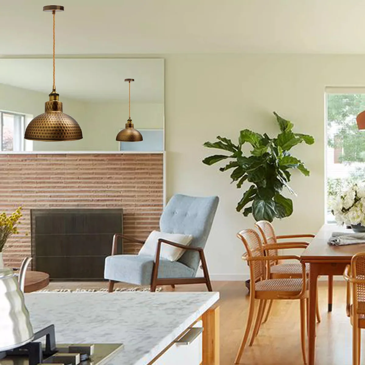 Brass dome pendant light with hammered metal shade hanging against a white background, showing adjustable drop length