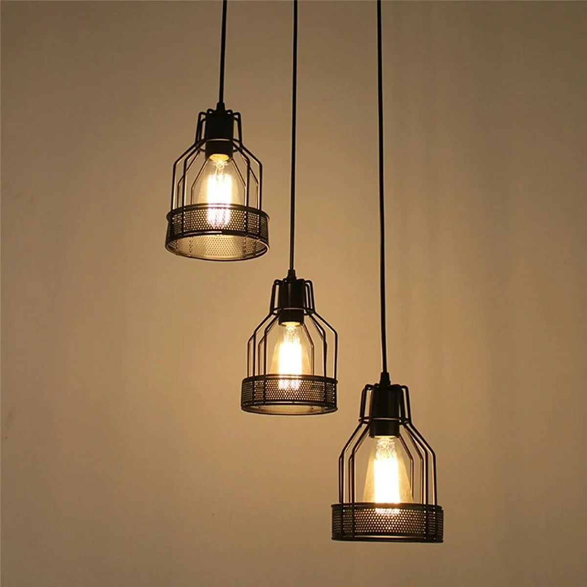Black industrial pendant with five adjustable metal cage arms and exposed Edison bulbs hanging from ceiling mount