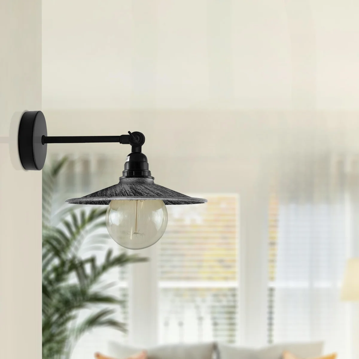 Industrial wall light with flat metal shade, short adjustable arm, and hardwired wall mount in vintage style