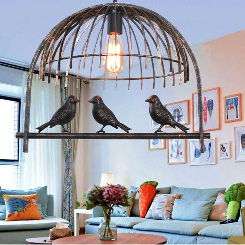Vintage brass pendant light with industrial birdcage design and black fabric cable hanging from ceiling canopy