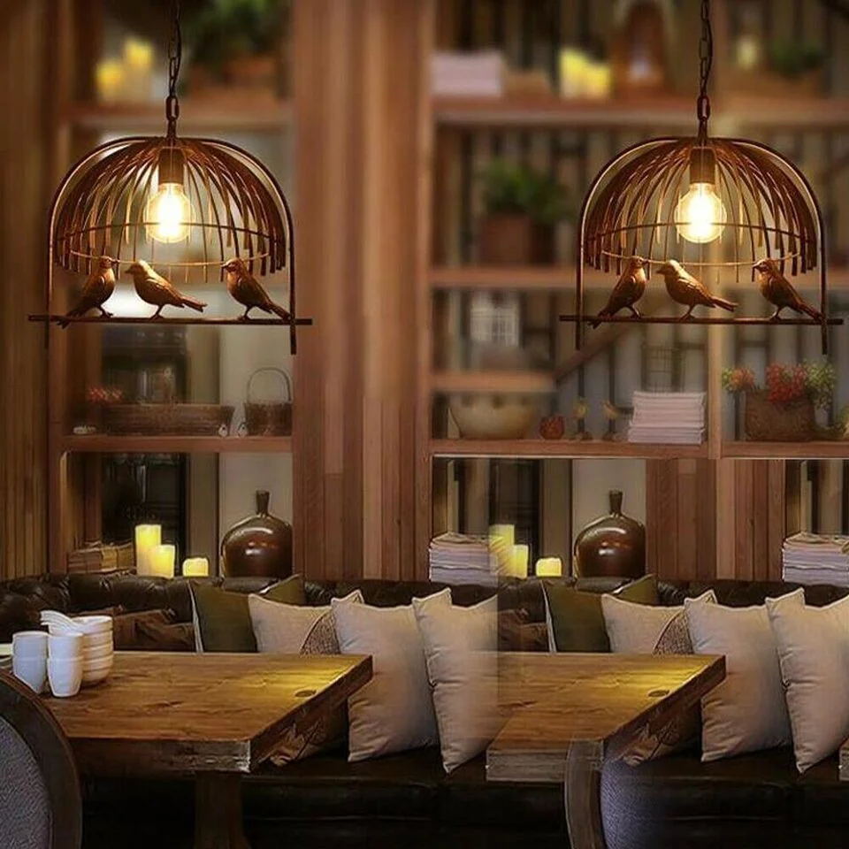 Vintage brass industrial birdcage loft style pendant lamp with black fabric cable hanging from ceiling in a room setting