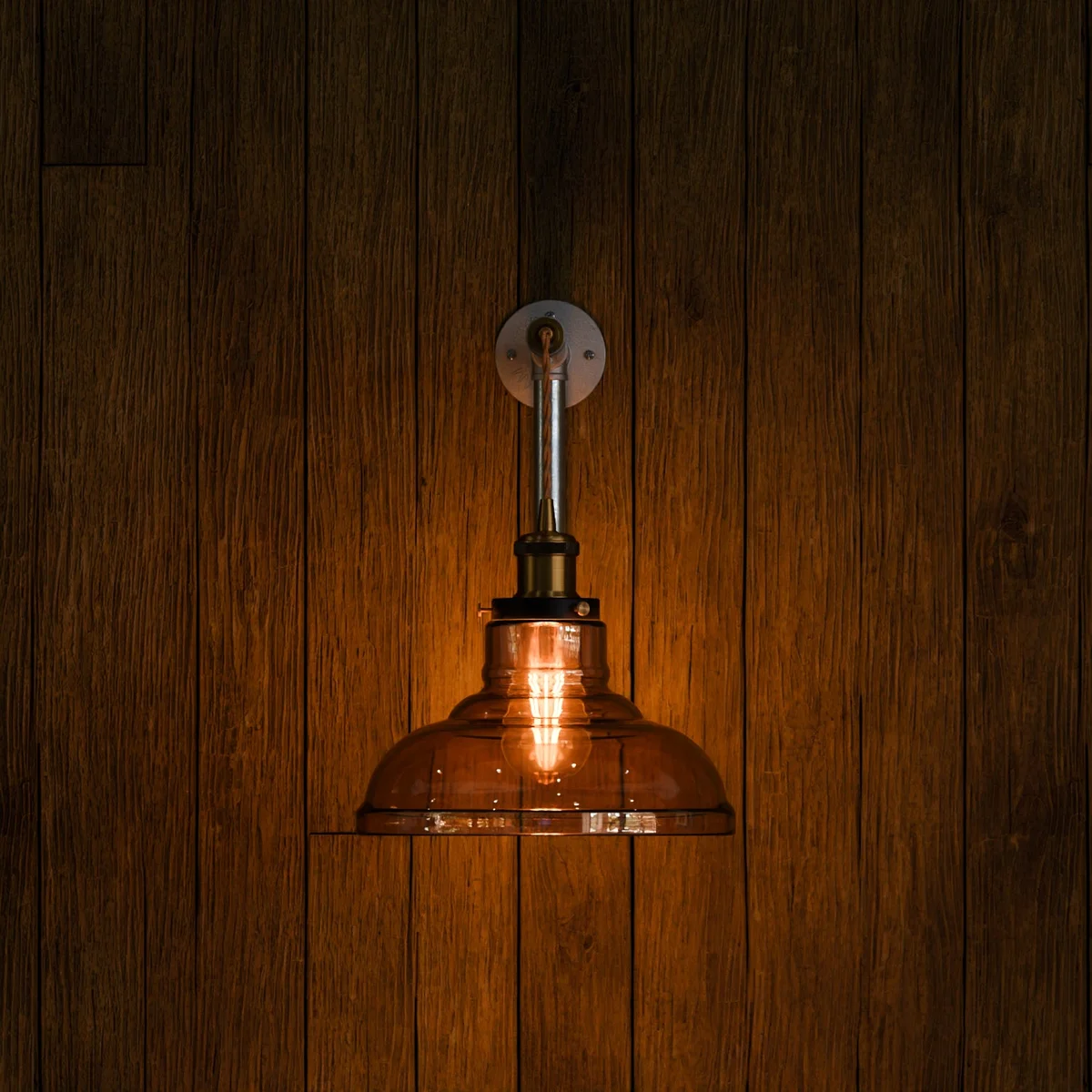 Retro industrial wall light with amber glass shade and galvanized iron conduit pipe.