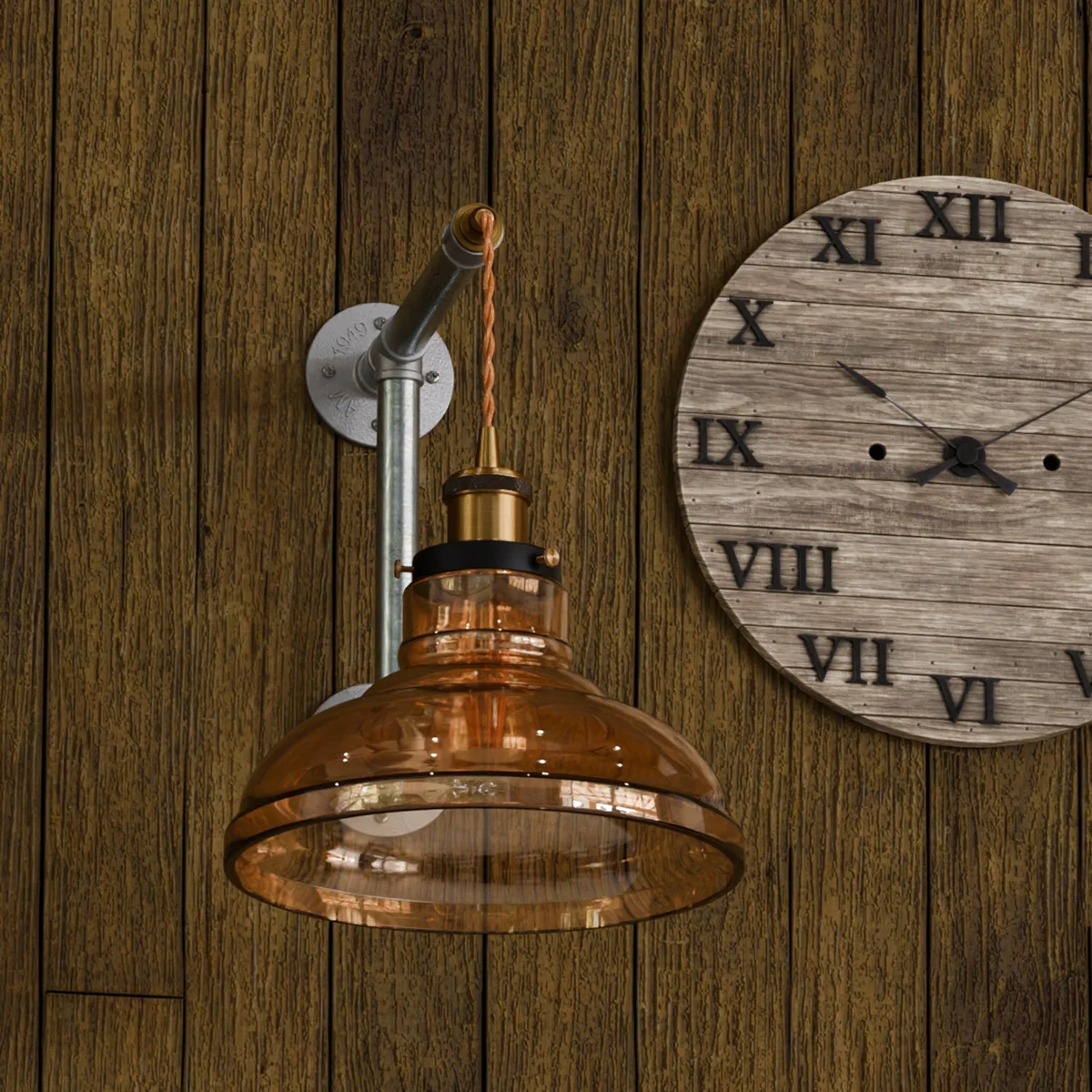 Galvanized iron pipe light with amber glass shade, industrial wall fixture, adjustable fabric cord.