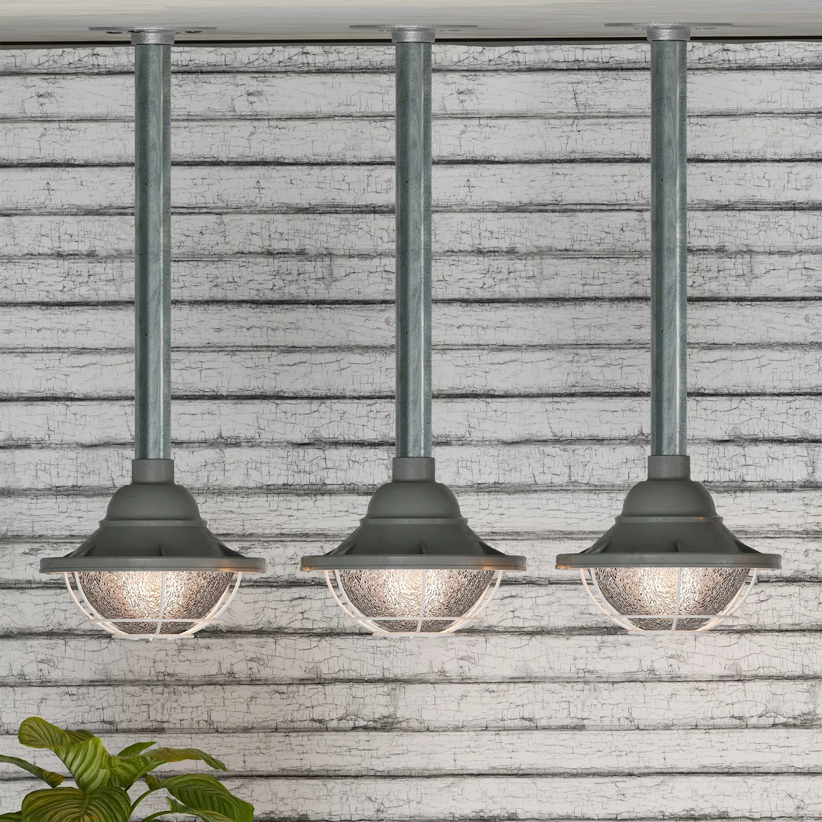 Yellow industrial ceiling pendant light with 21cm metal cage and 25cm conduit pipe hanging from ceiling mount