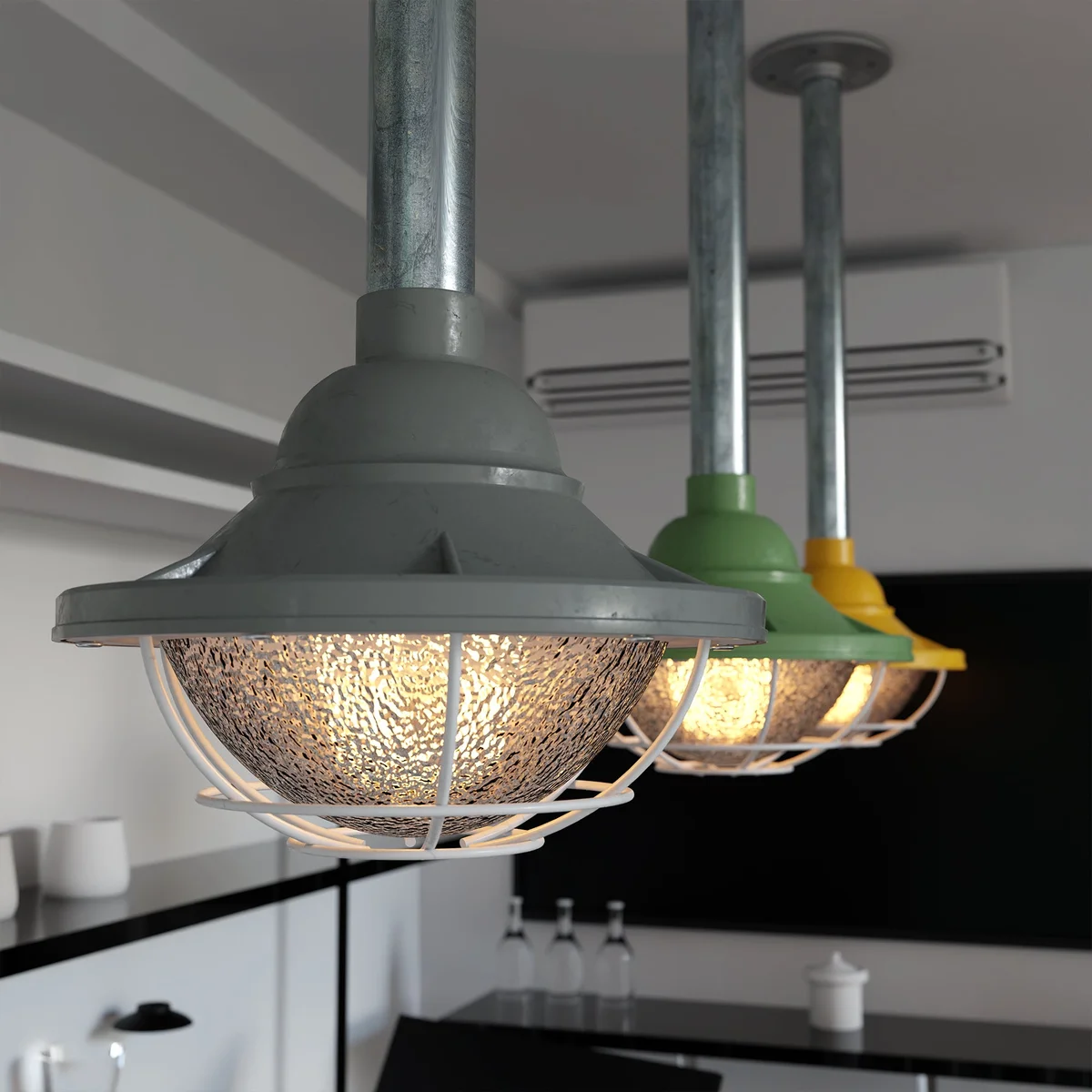 Yellow industrial pendant light with metal cage, clear glass shade, and 30cm conduit pipe hanging from ceiling