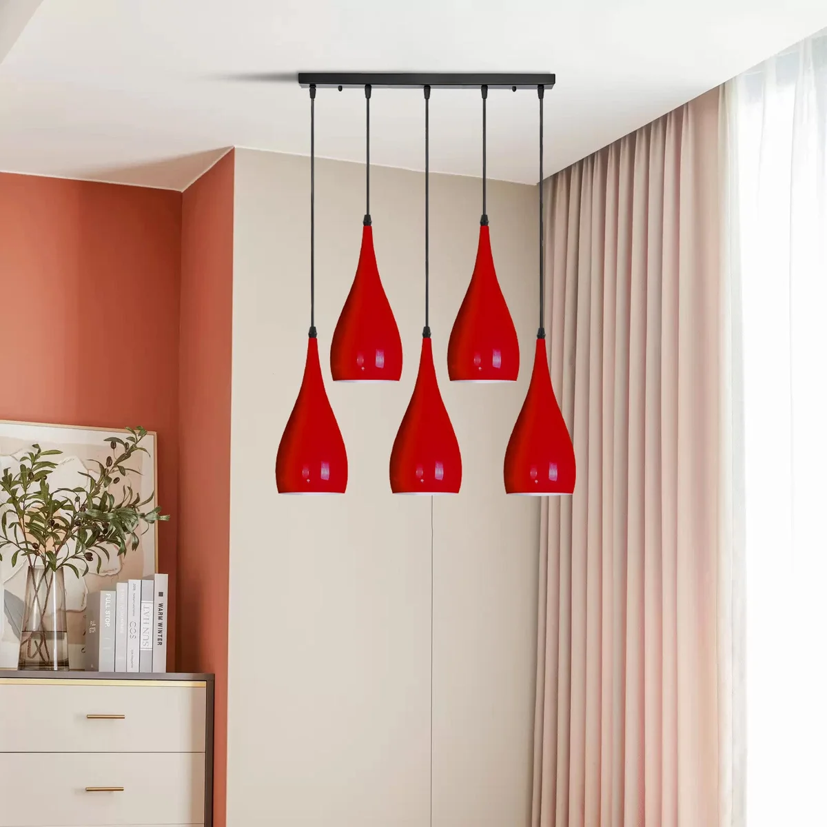 Five glossy teardrop light shades on an adjustable cord pendant hang from a metal frame in red, yellow, green or black