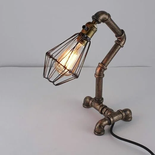 Steampunk table lamp with retro water pipe design, metal cage shade, and vintage Edison bulb in brushed copper finish