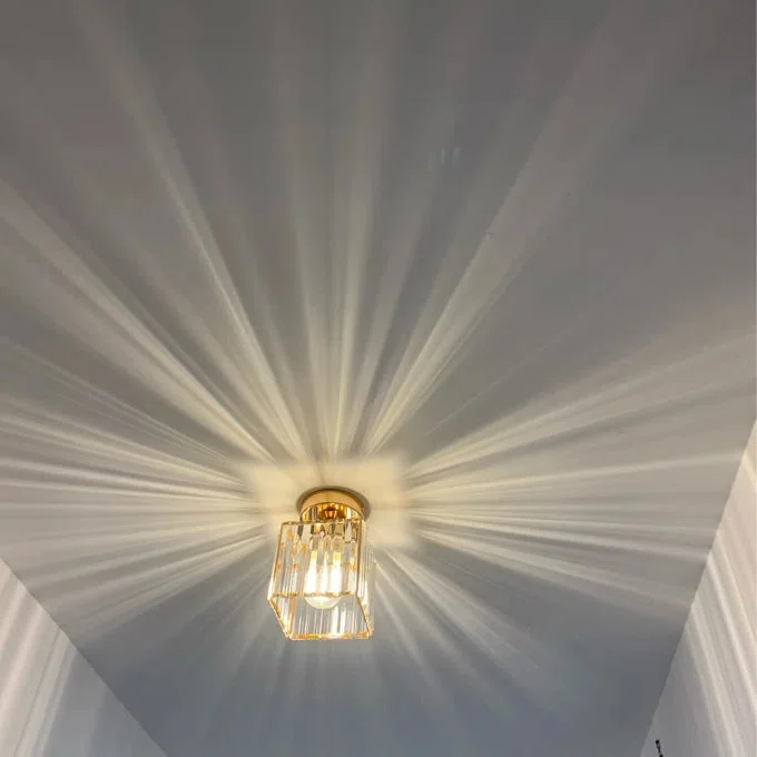 Two small square crystal flush mount dimmable ceiling lights with metal cage design and faceted crystals on white background