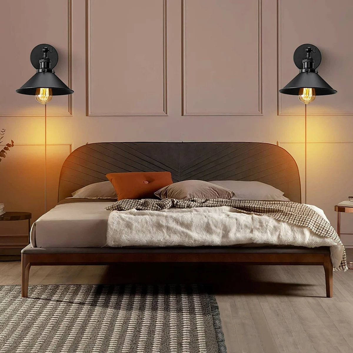 Black industrial cone-shaped plug-in wall lamp with adjustable arm and UK plug, mounted on a white wall