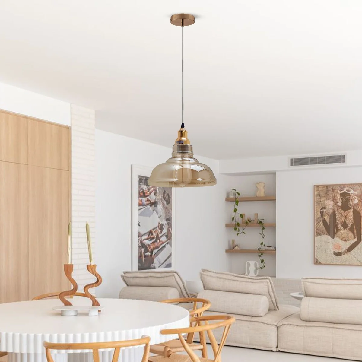 Amber glass pendant light with brass fixture hanging from ceiling, vintage style amber shade.
