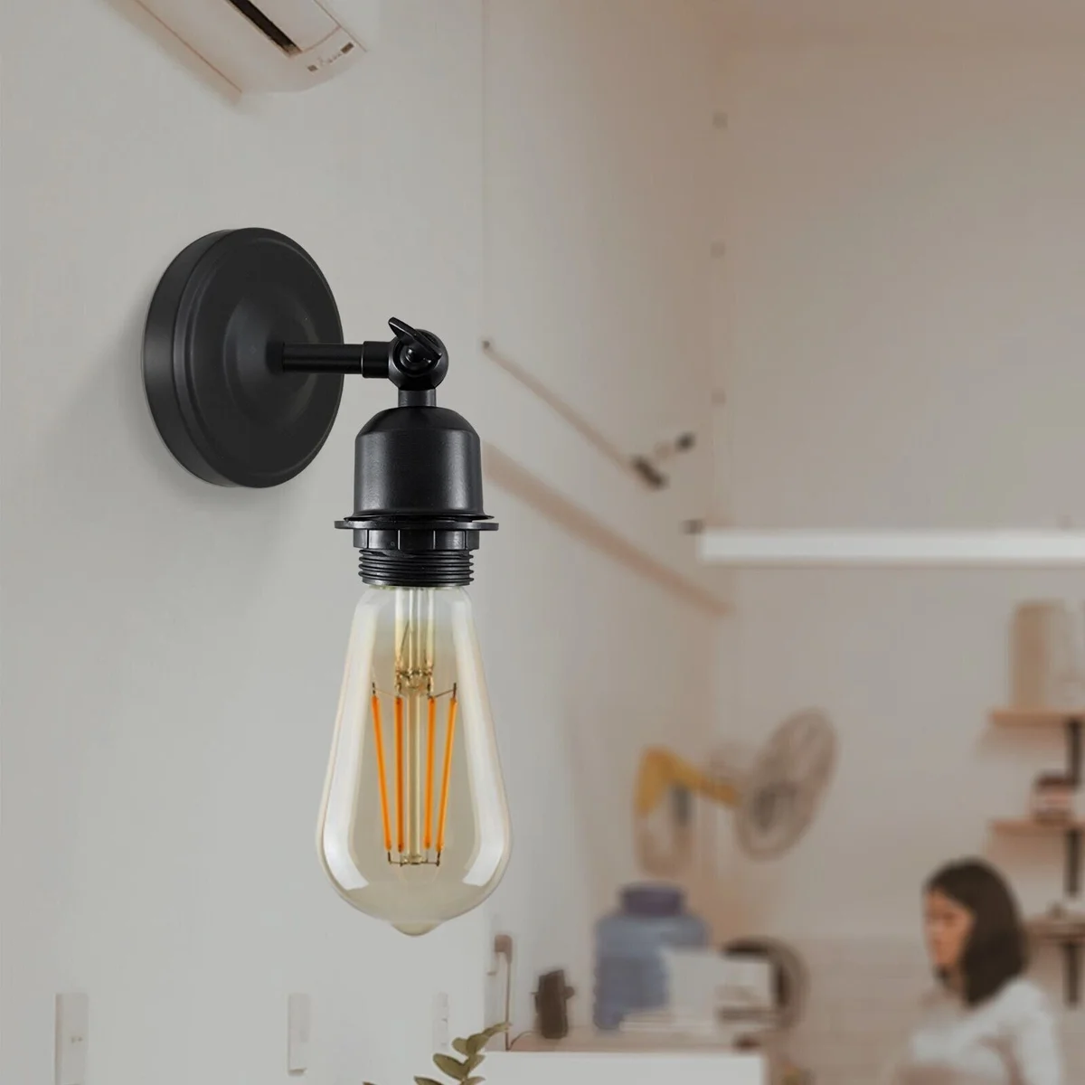 Vintage Industrial E27 bulb wall light with adjustable metal arm in black, mounted on a white wall for focused lighting