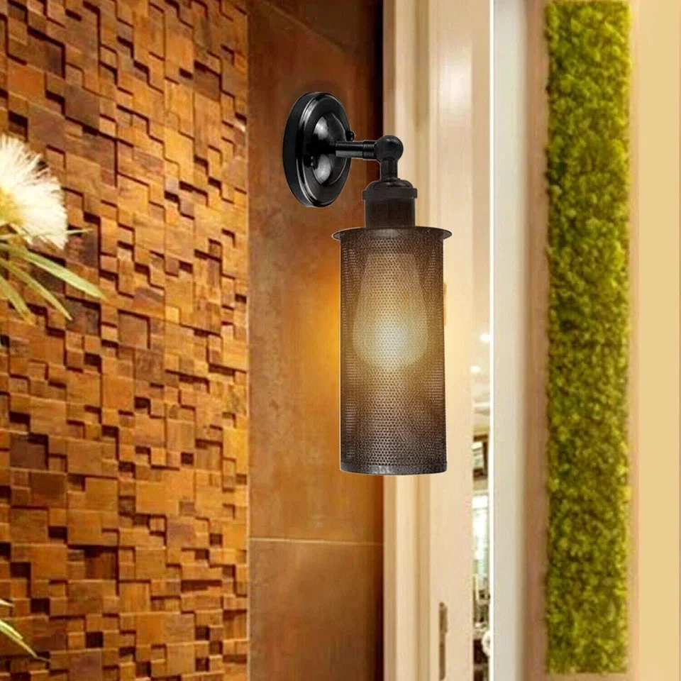 Vintage wall lamp with adjustable metal cage and black finish mounted on a wall, showing industrial retro design details