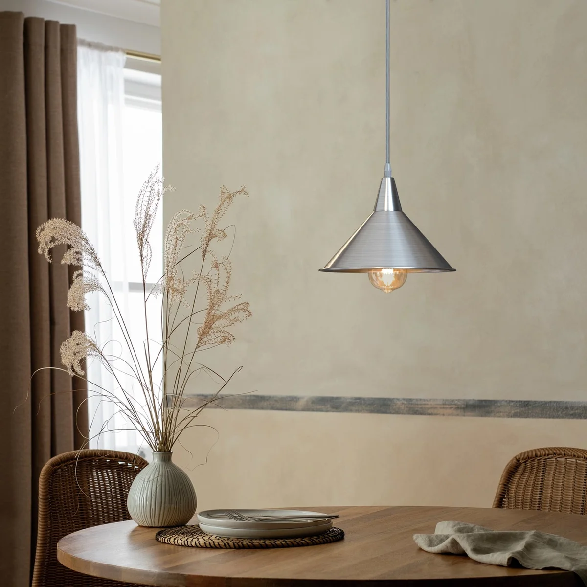 Modern chrome metal pendant light with cone shade and adjustable cable pendant hanging from ceiling mount