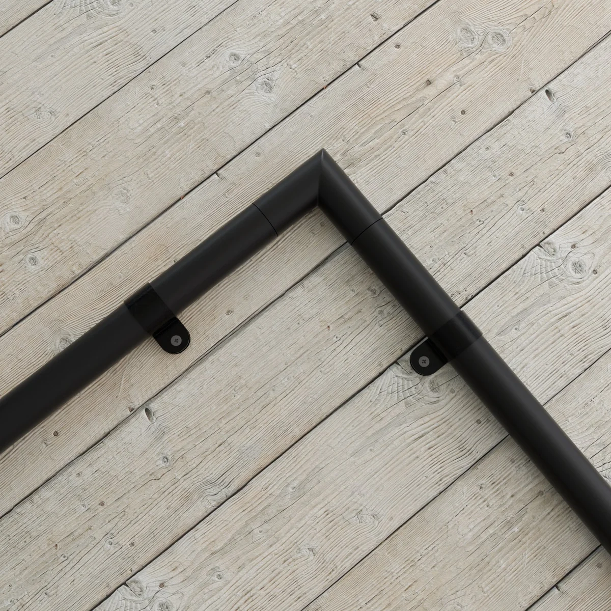 Black plastic P style cable clips with rubber lining and dual mounting holes for securing cables and hoses in harsh environments