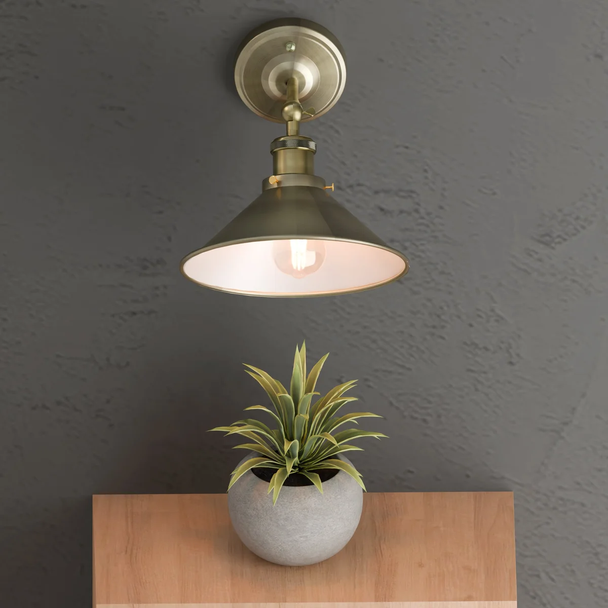 Black metal adjustable wall light with arm extended, mounted on white wall, showing vintage industrial design details