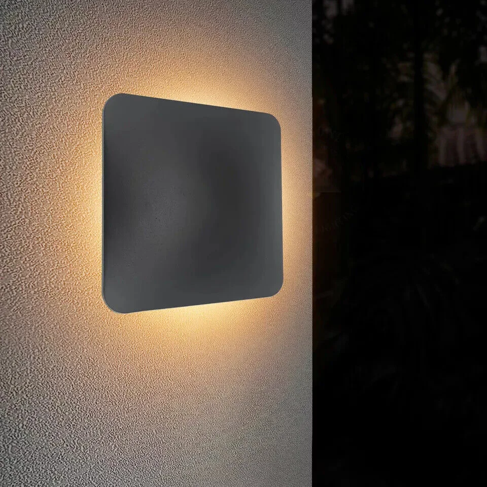 Modern black square LED up/down wall light mounted on outdoor wall, IP54 rated outdoor light with warm white glow