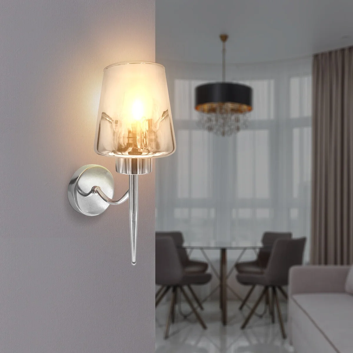 Modern chrome wall sconce with smoked glass shade mounted on a white wall, showcasing dimmable indoor lighting design