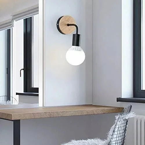 Wood metal wall sconce with white wooden backplate and black metal E27 lamp holder mounted on white wall