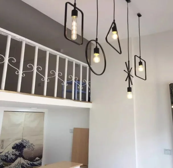 Black industrial pendant light with metal wire cage, round shape, hanging ceiling fixture with E27 holder and cable