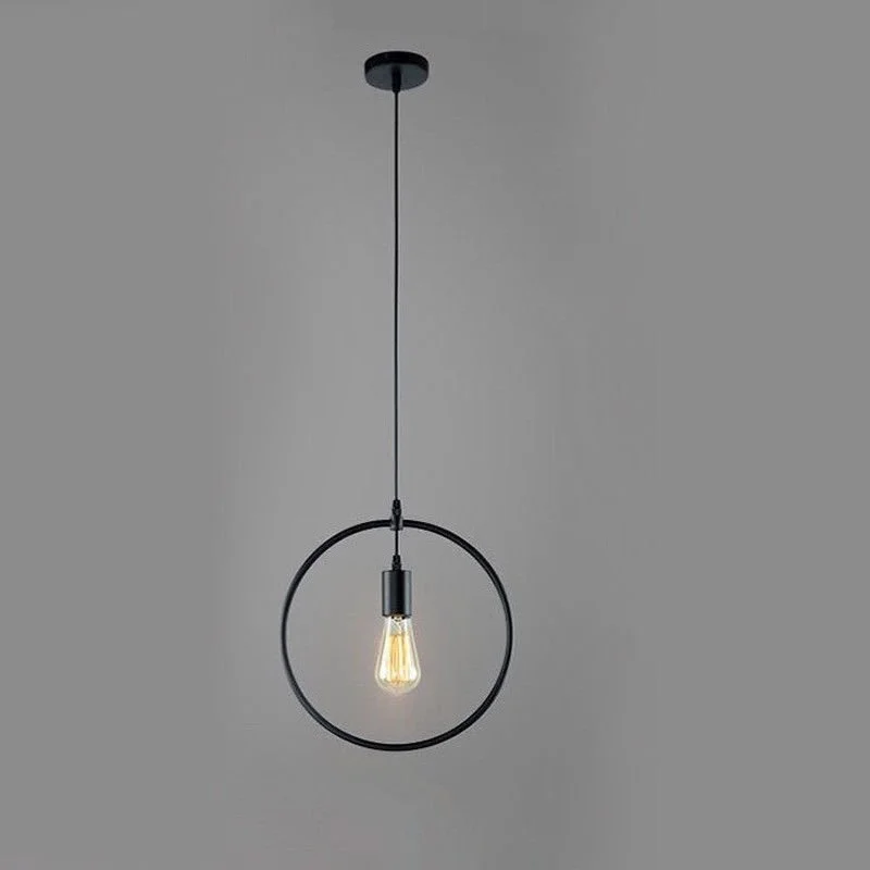 Black industrial pendant light with metal wire cage in round shape hanging from ceiling with exposed bulb holder and cable