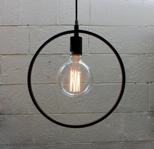 Black industrial pendant light with metal wire cage in triangle shape hanging from ceiling, no bulb included.