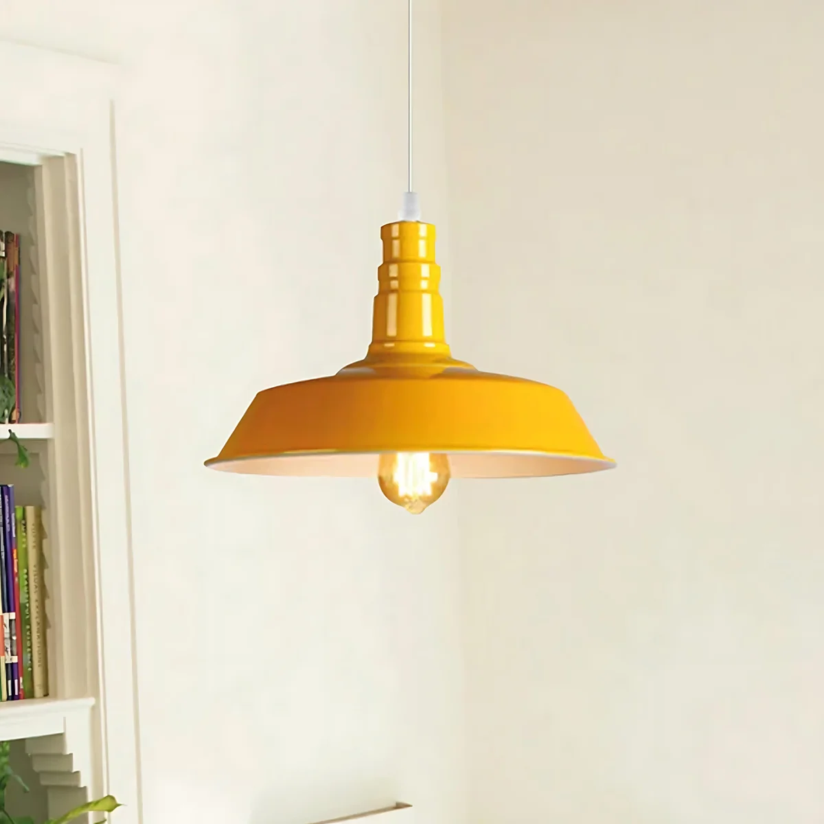 Yellow modern kitchen pendant light with metal barn slot shade hanging from adjustable cord against white background
