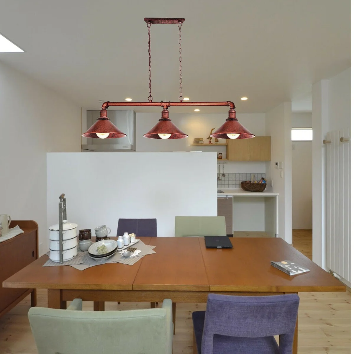 Steampunk ceiling light featuring three brushed silver pipe sconces, suspended low with black brackets.