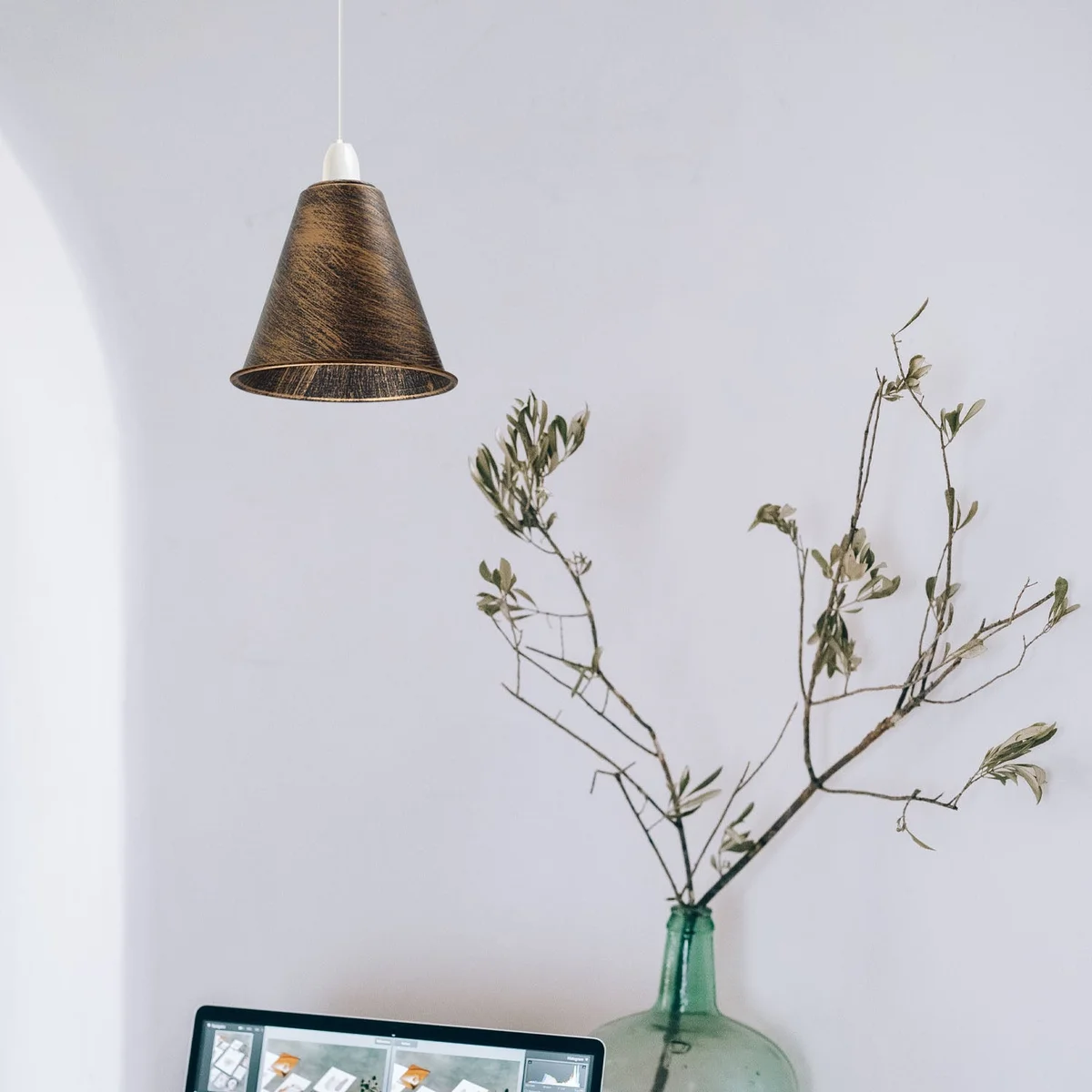 Black industrial ceiling lamp shade with metal construction and concrete effect finish hanging from ceiling