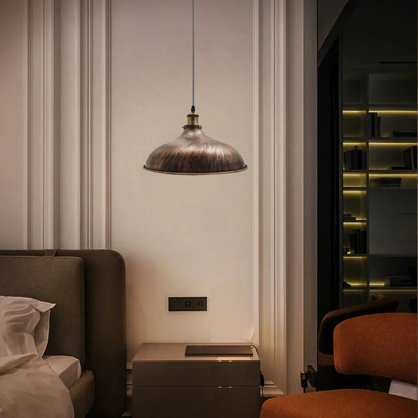 Vintage brushed copper pendant light with matte black sculptural shade hanging from ceiling cable