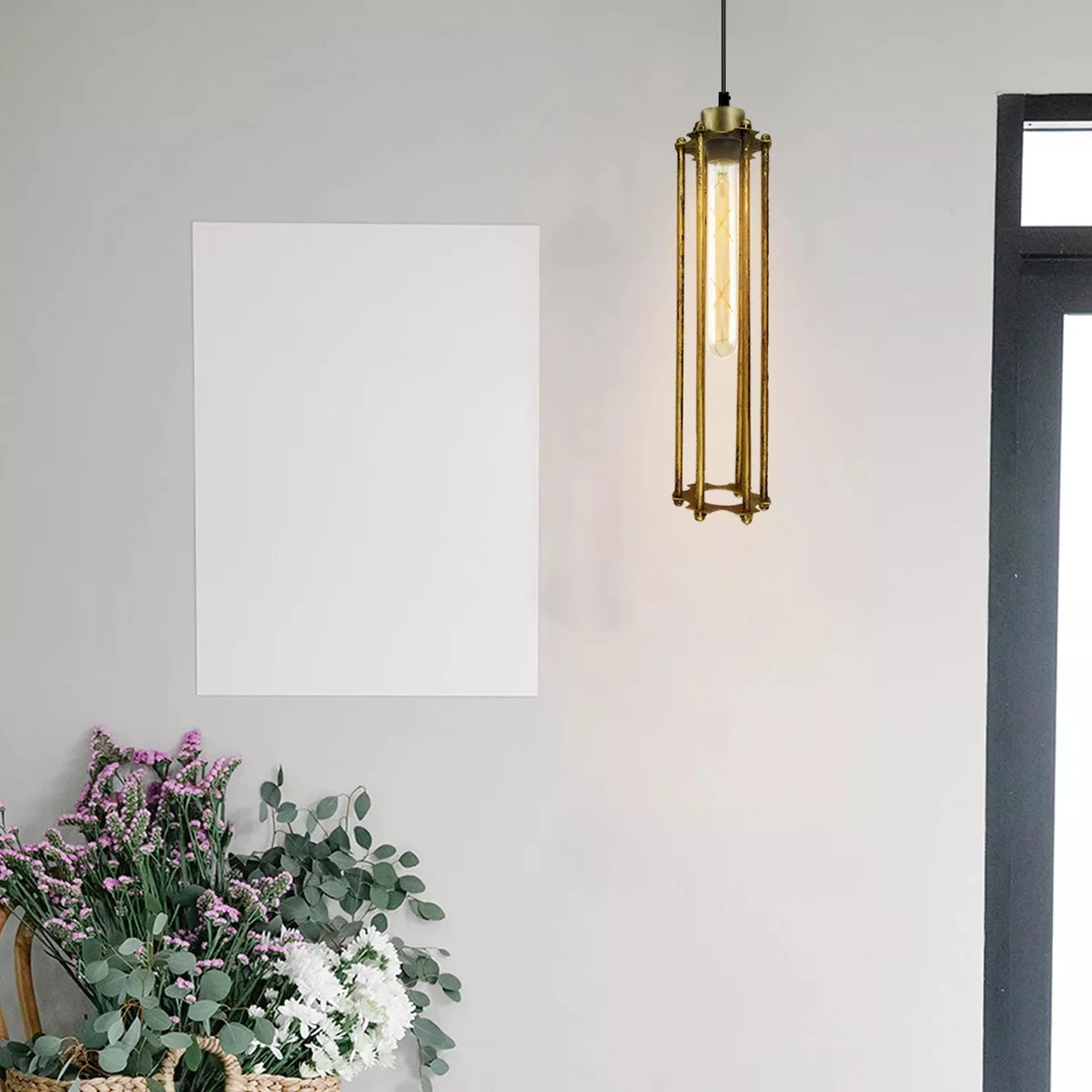 Adjustable industrial style chandelier with brushed brass cage shade and warm white LED bulb hanging from ceiling rose