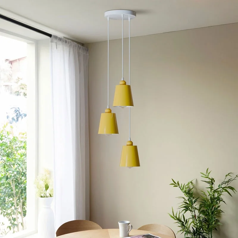 Industrial-style adjustable pendant light with three round metal shades in green, blue, grey, and yellow colors hanging from ceiling rose