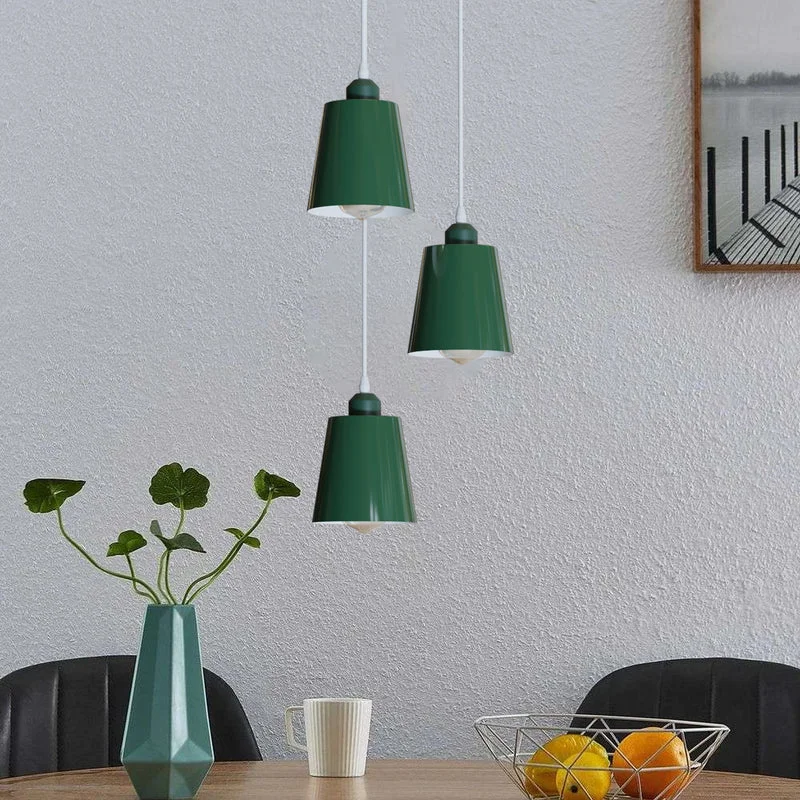 Industrial pendant light with three round metal shades in green, blue, grey, and yellow, adjustable cables, ceiling mounted