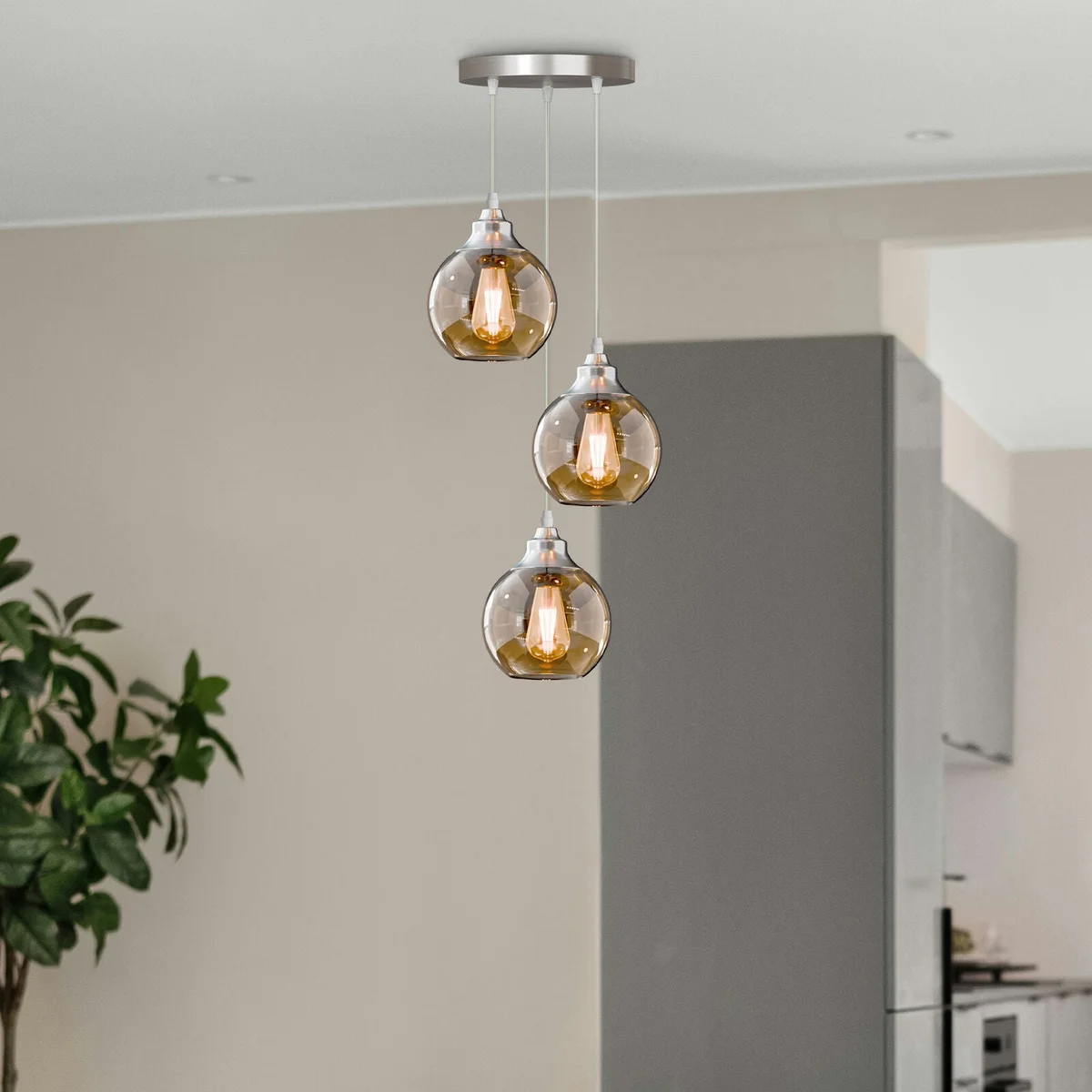 Three-light modern glass pendant light with teardrop glass shades and warm copper finish hanging cords adjusted
