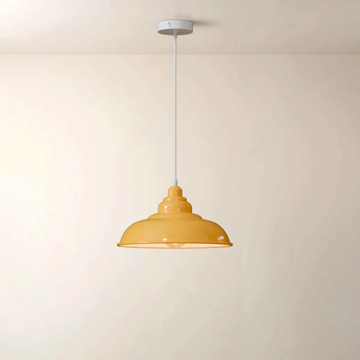 Vintage pendant light with a classic metal shade hanging from a ceiling, showcasing retro industrial style design
