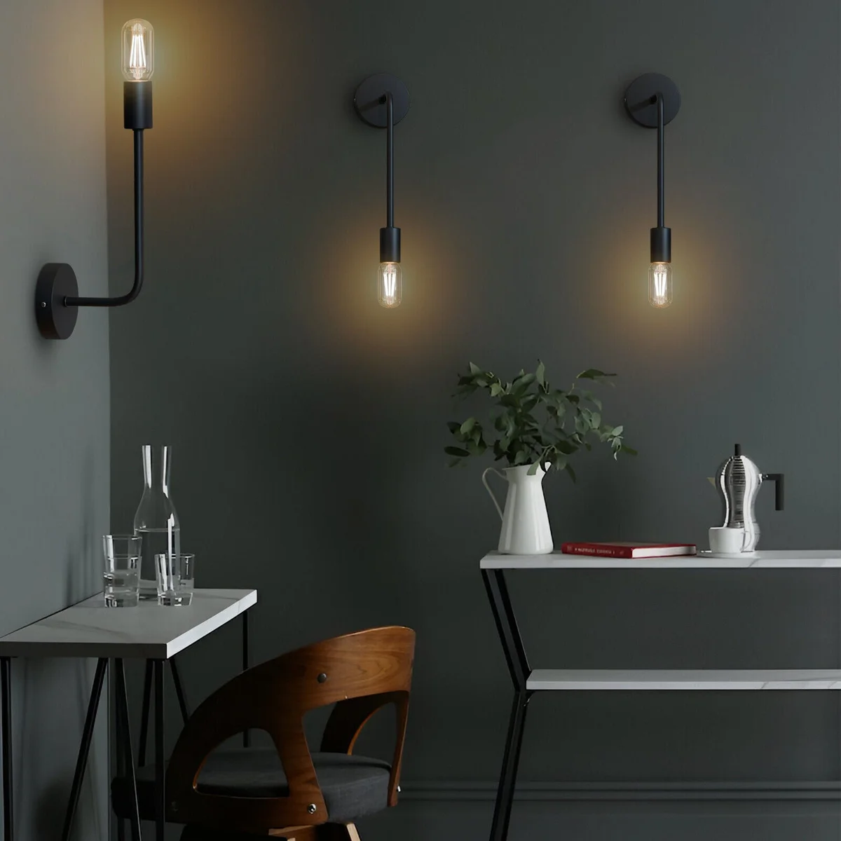 Modern wall light with curved metal arm and cylindrical E27 socket mounted on a round ceiling rose, industrial style