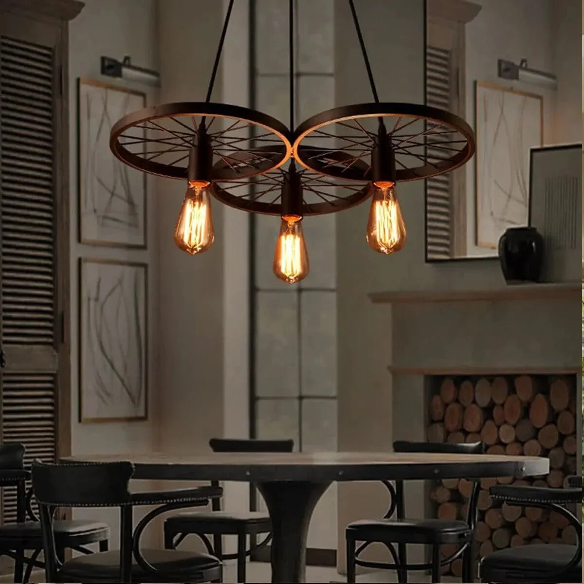 Rustic industrial pendant light with three Edison bulbs on a vintage wagon wheel metal frame hanging indoors
