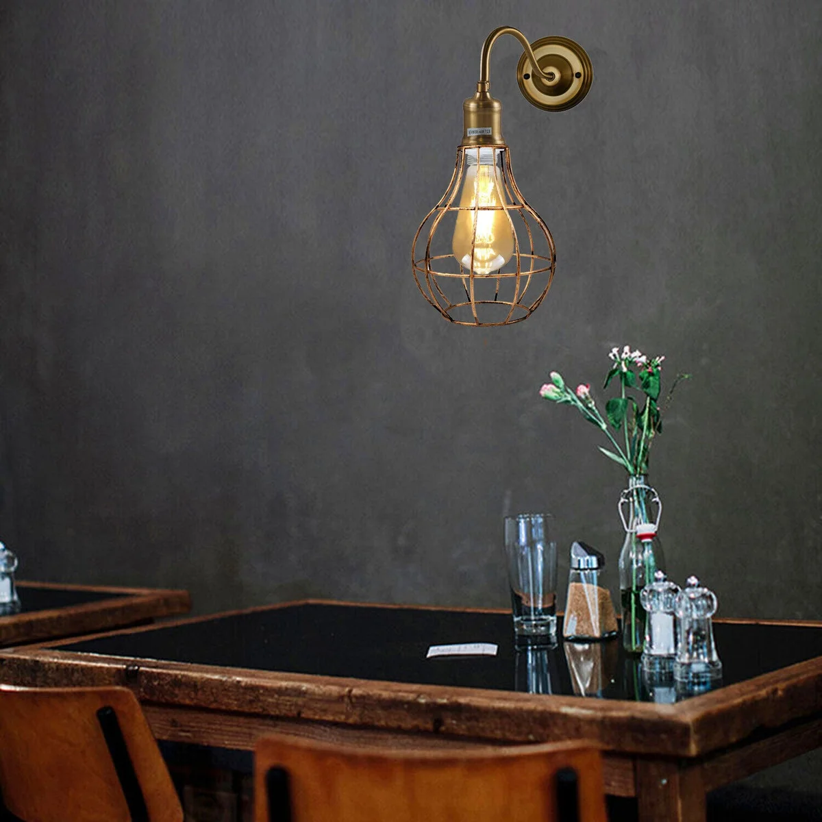 Cage wall sconce in copper and rustic red with round pendant, geometric wall sconce styled for contemporary interiors.