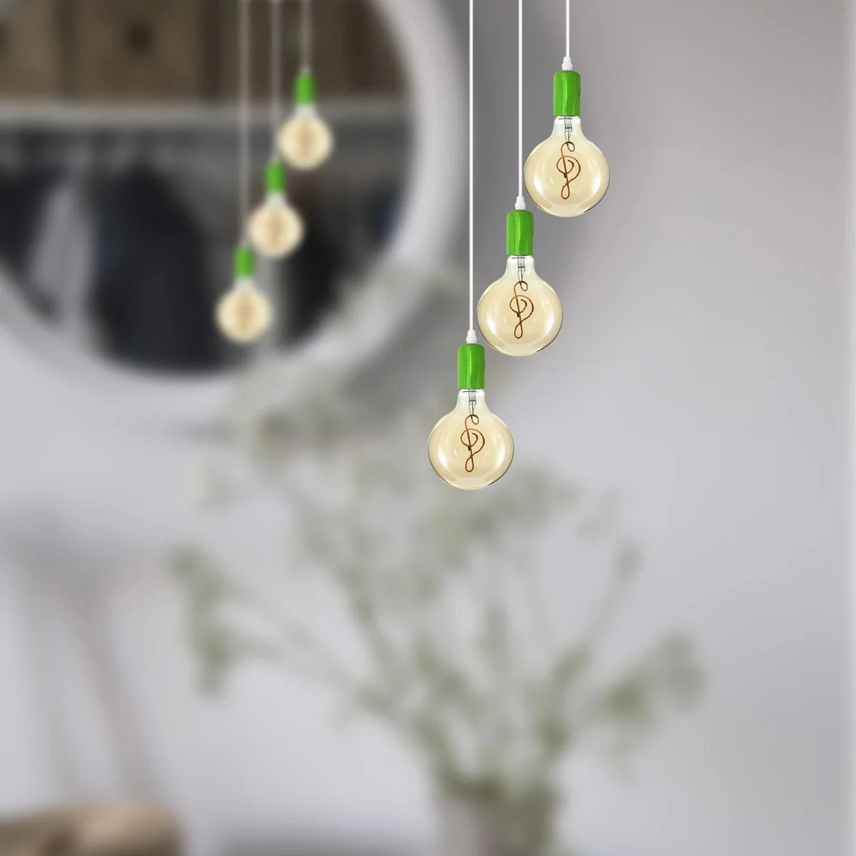 Vintage ceiling pendant with three exposed filament bulbs and metal frame, suspended by adjustable cables