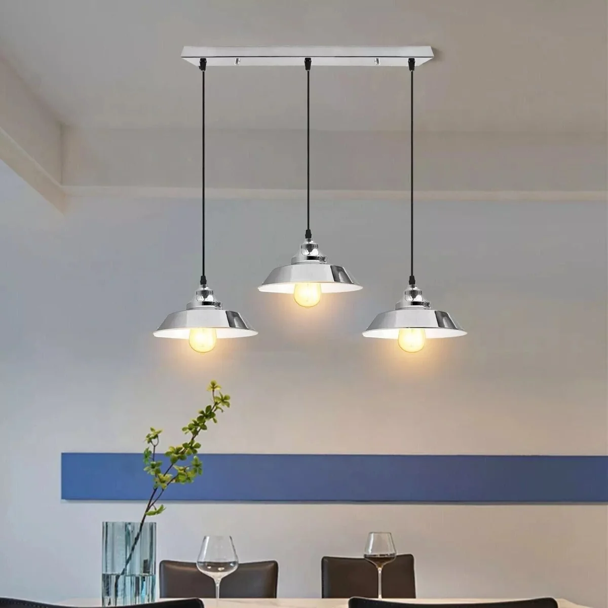Retro chrome pendant light with three metal shades hanging from PVC cables, vintage industrial ceiling lamp design