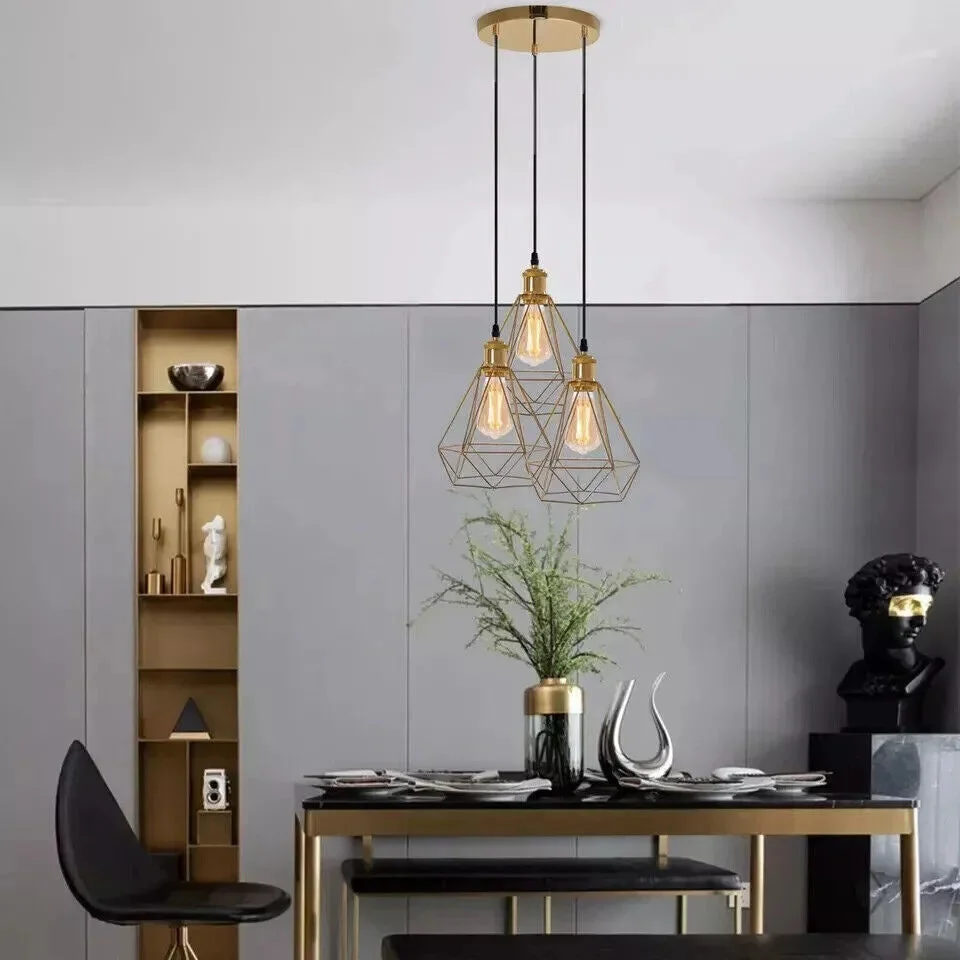French Gold industrial adjustable drop pendant with three metal cage lights hanging from adjustable cables