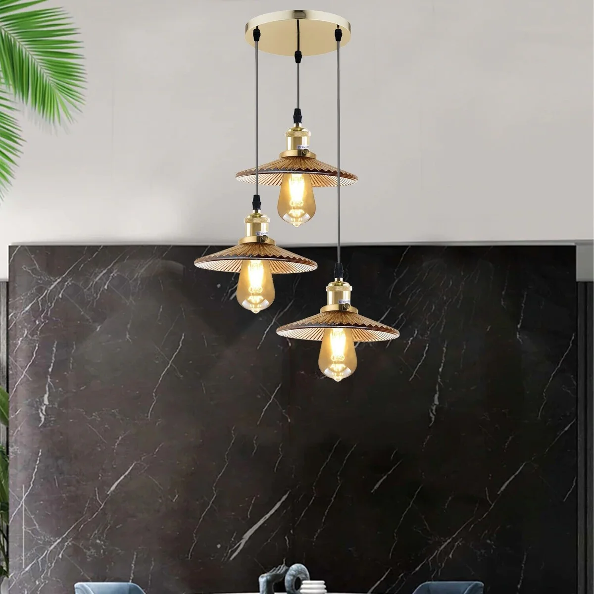 Vintage ceiling pendant light with amber glass shades and matte metal finish, featuring three bulbs for adjustable lighting