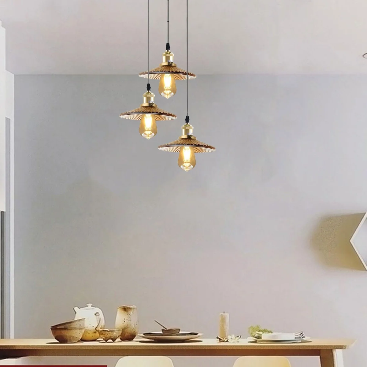 Vintage industrial amber glass ceiling light with three pendant shades and metal fixtures hanging indoors