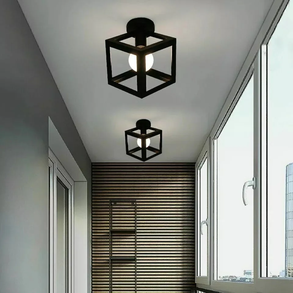 Black metal cage ceiling light flush mount with geometric design and included bulb, ideal for kitchen or cafe lighting