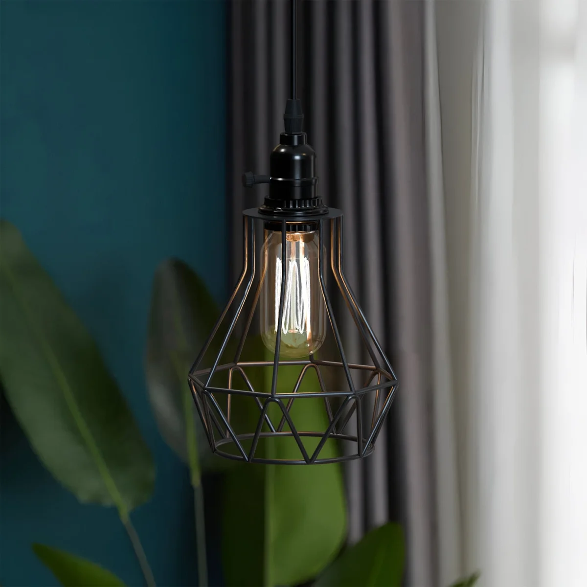 Black industrial pendant light with geometric metal cage, hanging from adjustable cable with inline on/off switch, lit in dining room