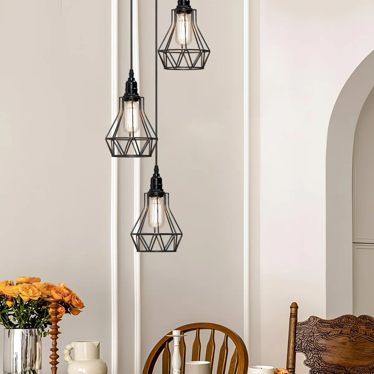 Black industrial pendant light with geometric metal cage and adjustable hanging cable shown in modern kitchen setting