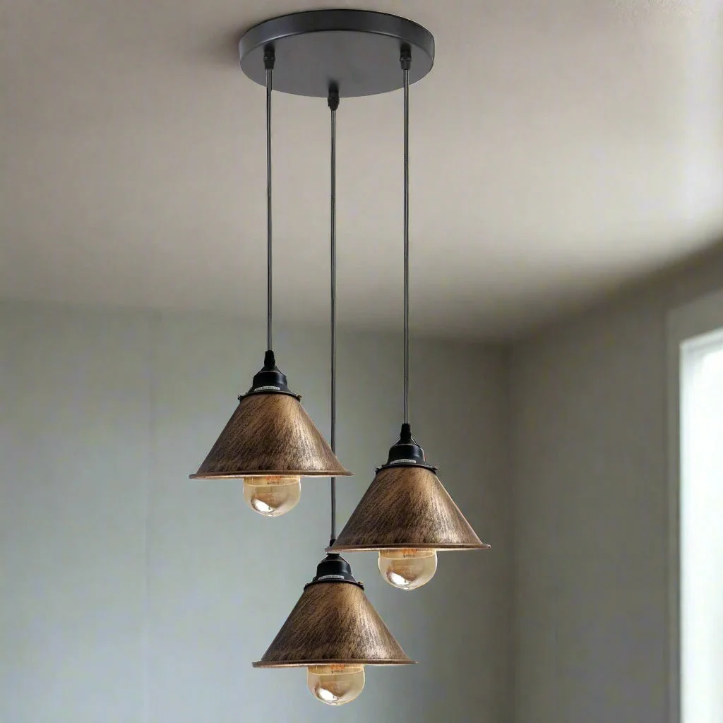 Vintage industrial pendant light with three brushed copper metal shades and black ceiling mount, adjustable cords