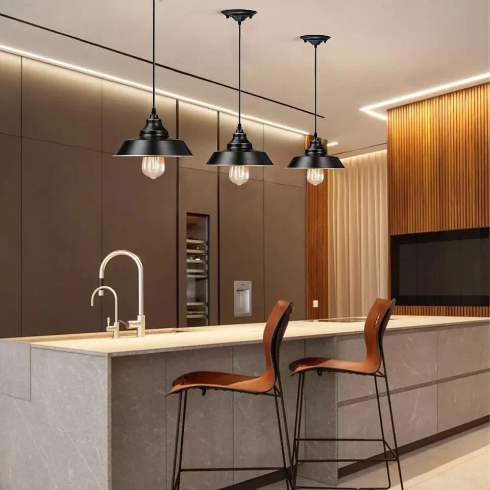 Vintage single head pendant light with sleek metal shade hanging from ceiling, showing curved metal body and exposed PVC cable.