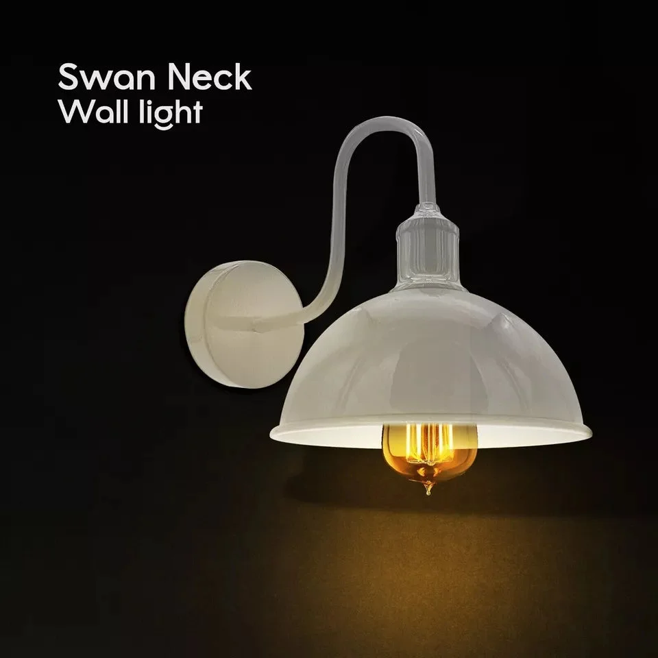 Vintage industrial wall light with black dome metal shade mounted on wall, suitable for indoor ambient lighting