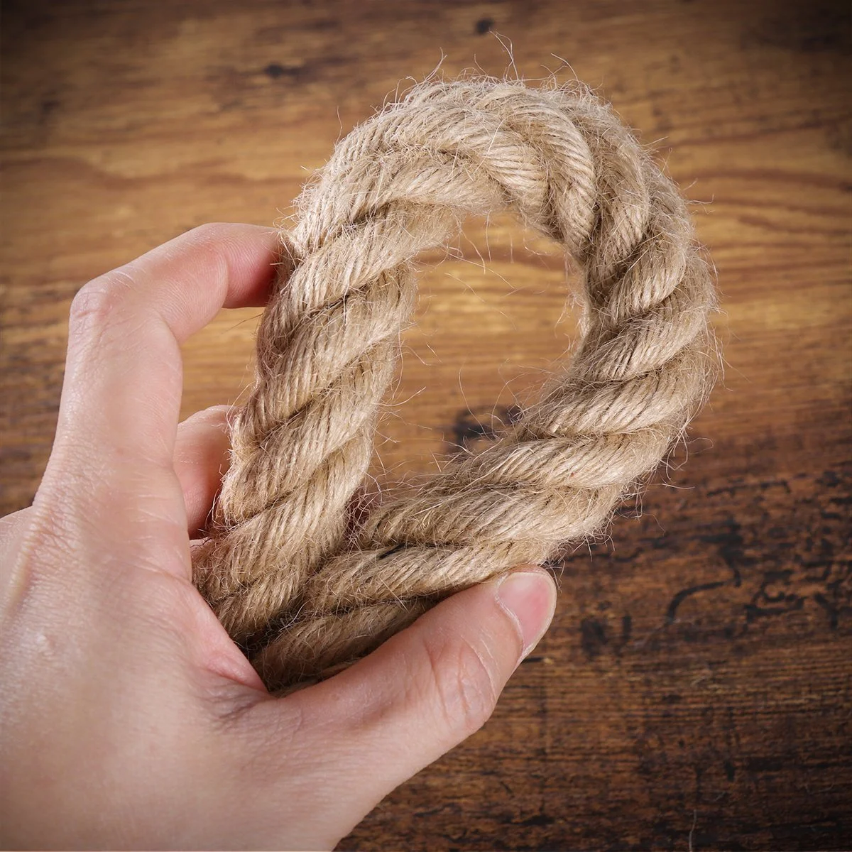Three-head rustic hemp rope lamp hanging from ceiling with natural hemp color and copper wire accents in vintage style