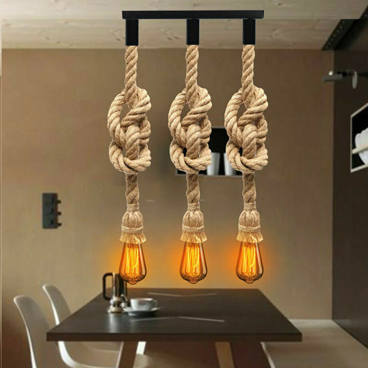 Three vintage industrial style hemp rope ceiling light pendants with copper fittings hanging against a white background